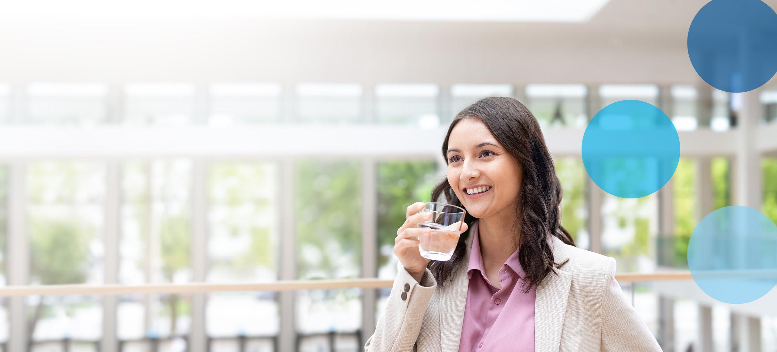 Woman in business suit holding water glass